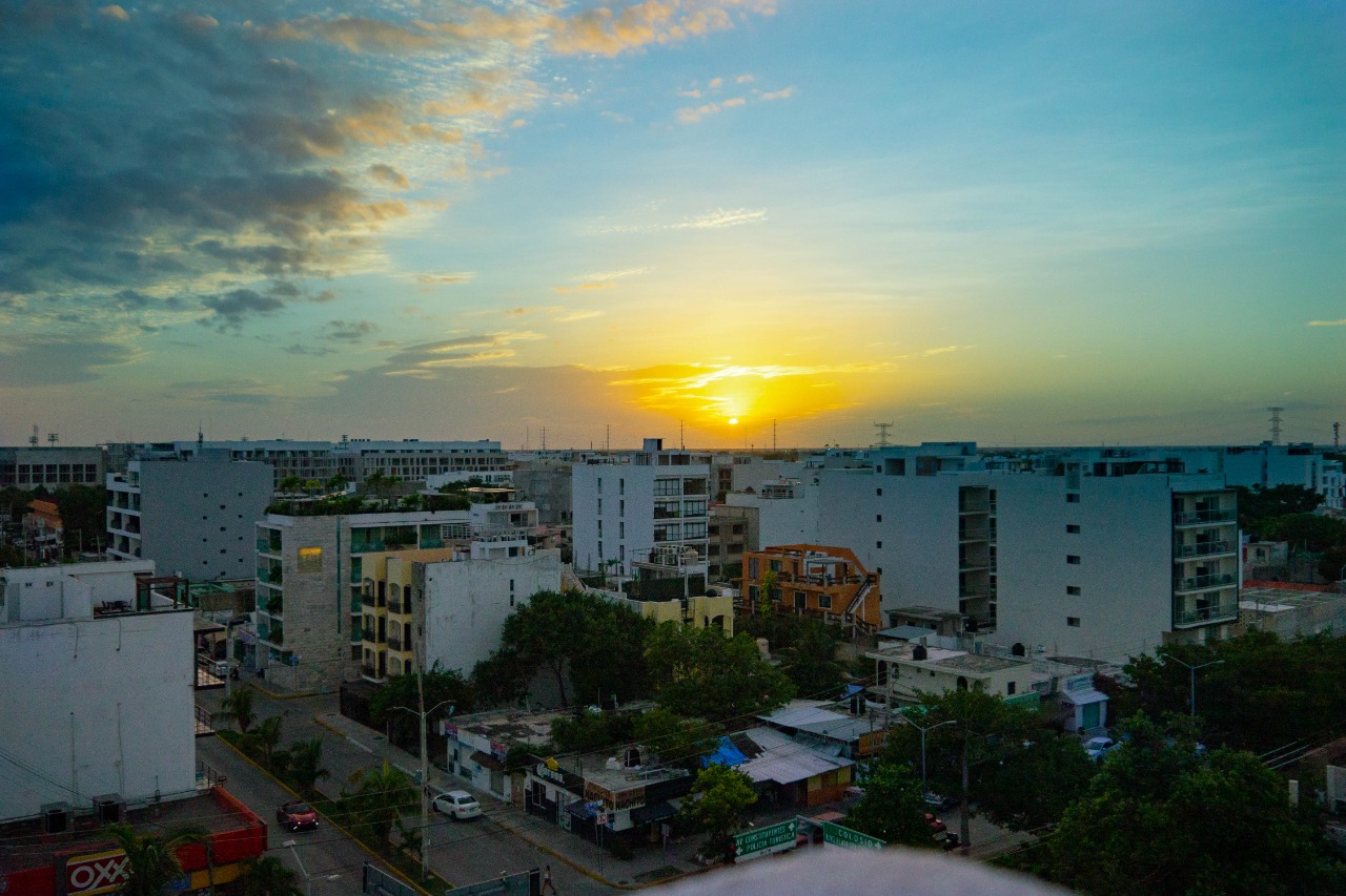 Aerial view of modern condos and residential buildings at sunset in Playa del Carmen, Riviera Maya – vibrant urban lifestyle in Mexico