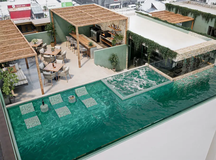Aerial view rooftop with swimming pool with jacuzzi and area lounge in downtown playa del carmen