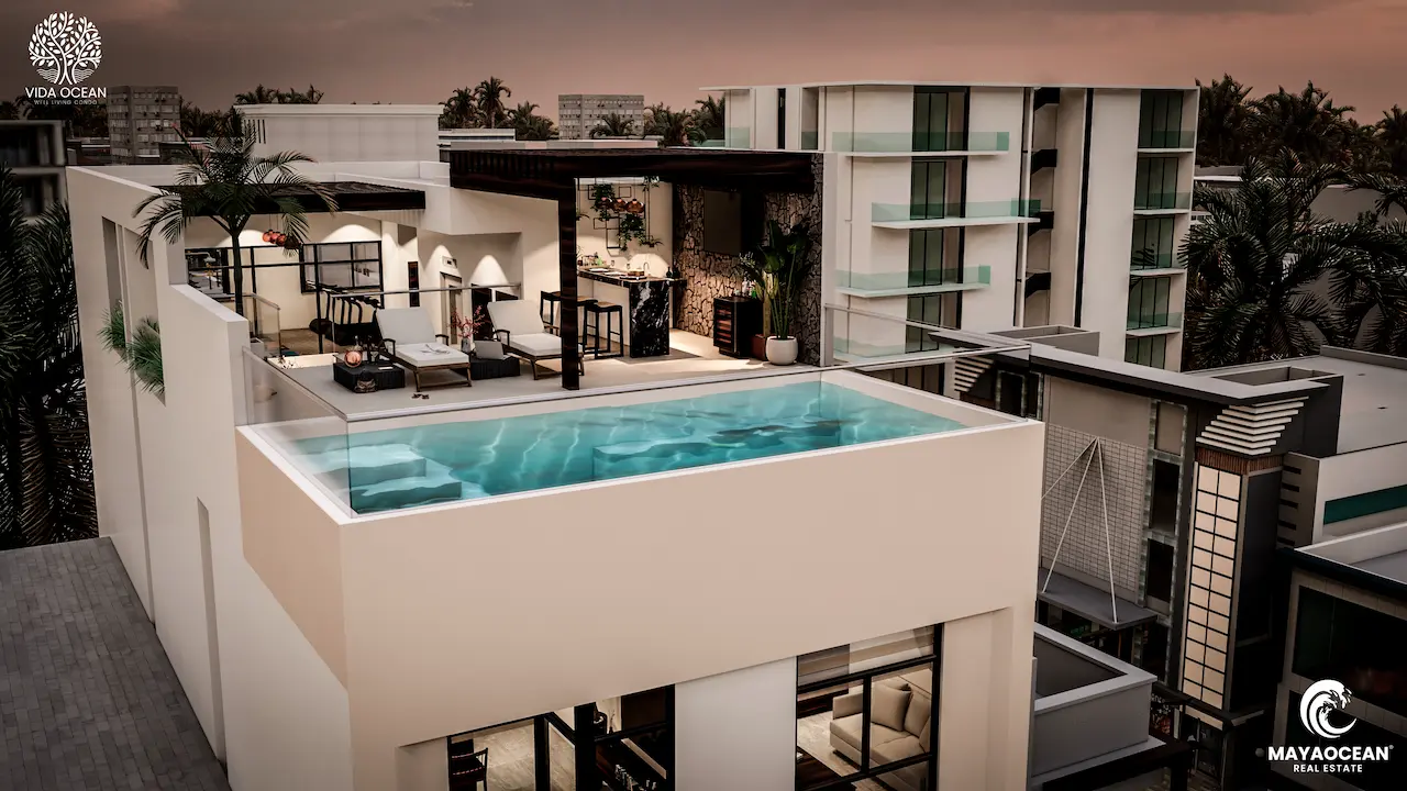 Downtown Playa del Carmen building with a rooftop pool offering panoramic sunset views, just a short walk from the beach.
