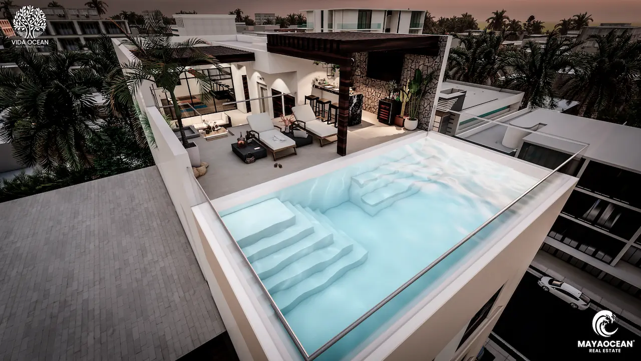 Downtown Playa del Carmen building with a rooftop pool offering panoramic sunset views, just a short walk from the beach.