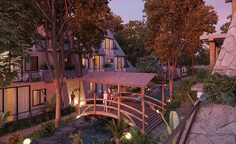 Residential complex Tulum Aldea zama bridge over water sunset