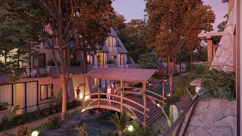 Residential complex Tulum Aldea zama bridge over water sunset